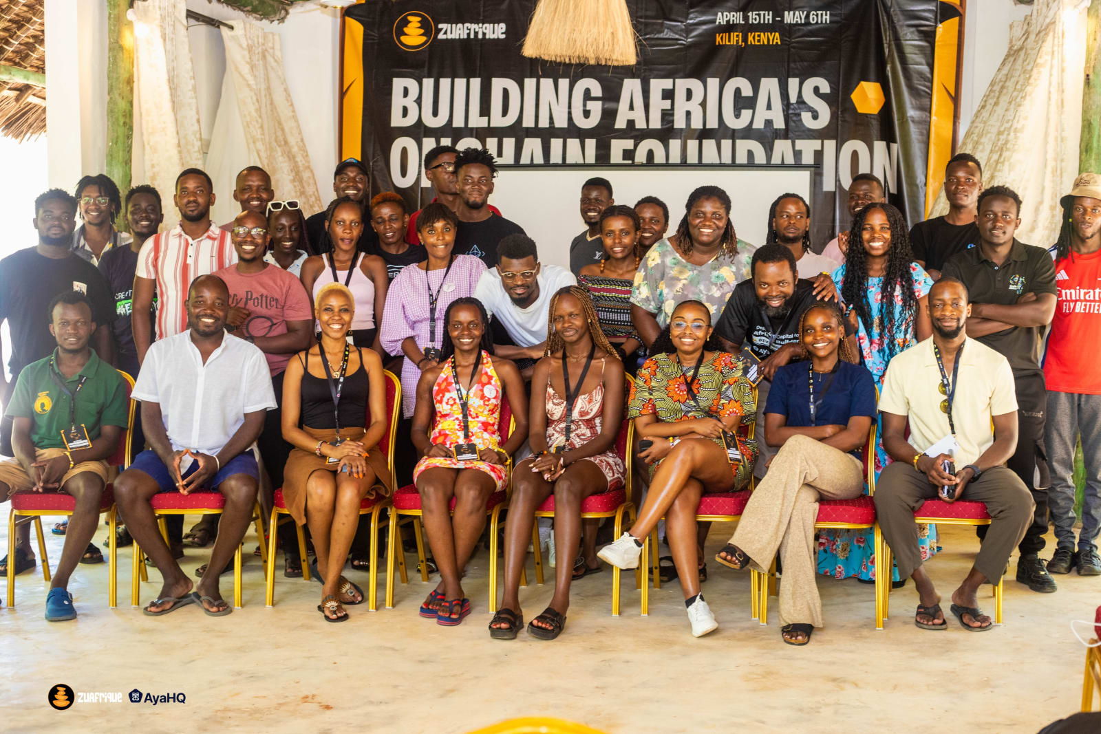 The 2025 cohort of ZuAfrique residents posing for a group photo in Kilifi, Kenya, in front of the gathering's original banner.