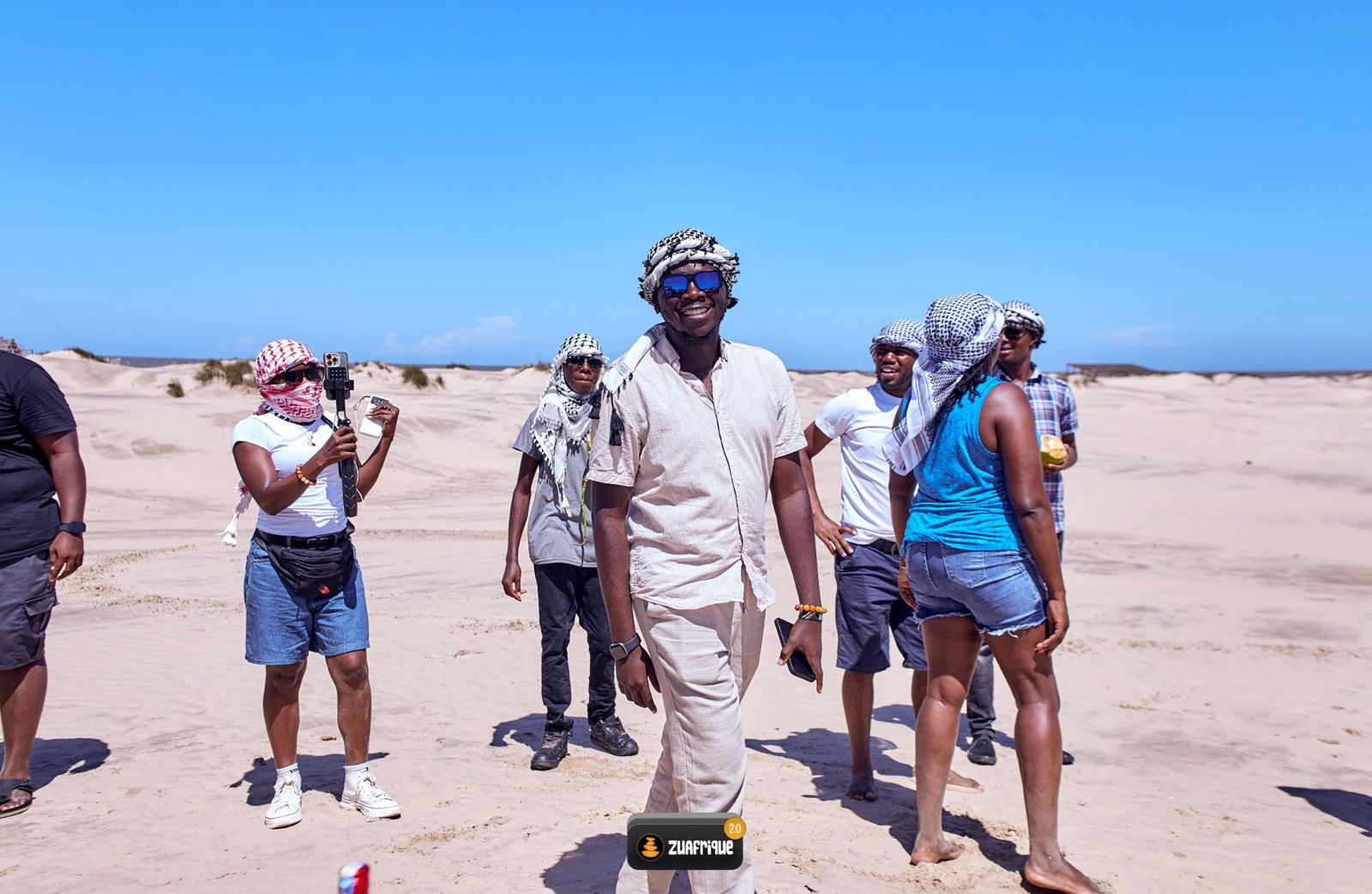 Residents walking together across the sand dunes on the final excursion of the 2026 residency.